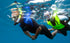 Two snorkelers underwater in clear blue water